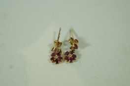A pair of 9 carat gold ruby and diamond cluster drop earrings
