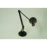 A black Angle poise lamp by Herbert Terry & Sons