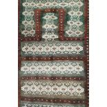 A Baluch prayer rug, with high woven pile and flat woven bands within one wide border, 76cm wide,