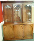 A Victorian mahogany bookcase with three glazed doors, above three arched panelled doors,