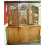 A Victorian mahogany bookcase with three glazed doors, above three arched panelled doors,