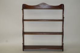 A mahogany four tier hanging waterfall set of shelves, with serpentine sides, overall 84cm high, 72.