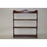 A mahogany four tier hanging waterfall set of shelves, with serpentine sides, overall 84cm high, 72.