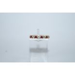 An 18 carat gold ruby and diamond half hoop ring,