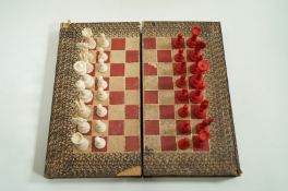 A late 19th century ivory chess set in leather lined book games box,