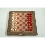 A late 19th century ivory chess set in leather lined book games box,