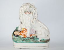 A 19th Century Staffordshire pottery figure of the British lion crushing Napoleon,