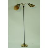 A 1960s three tier standard lamp, each with original black and yellow shades, on a brass base,