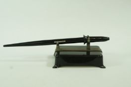 A pen metal desk stand, circa 1930, together with a  Waterman Skywriter lever fill fountain pen,