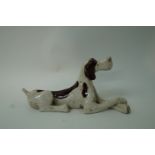 A 21st century pottery figure of a reclining dog, with crackle glaze,