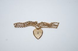 A heart shaped locket set with a rose cut diamond, 2 cm across; on a belcher link chain,