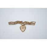 A heart shaped locket set with a rose cut diamond, 2 cm across; on a belcher link chain,