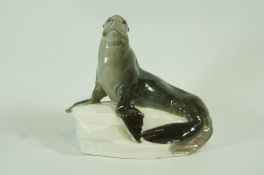 A Meissen porcelain figure of a sea lion on a rock, crossed swords mark,