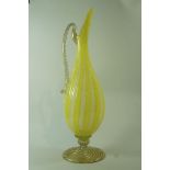 An early 20th century Venetian glass ewer, with gilded loop handle and flared foot,