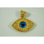A Turkish eye pendant, set with a paste, stamped '14K', 14.
