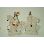 A pair of 19th century Staffordshire pottery figures of a lady on horseback and her companion,