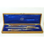 A Mappin and Webb horn and silver mounted carving set in an oak case,