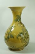 An unusual Lladro porcelian vase, moulded with flowering branches on a yellow ground,