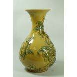 An unusual Lladro porcelian vase, moulded with flowering branches on a yellow ground,