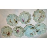 A Limoges porcelain desert service printed and painted with flowering branches on a blue ground,