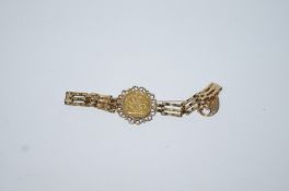 A 1903 half sovereign, mounted to a 9 carat gold gate link bracelet with a padlock clasp,