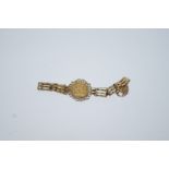 A 1903 half sovereign, mounted to a 9 carat gold gate link bracelet with a padlock clasp,