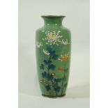 A 20th century cloisonne vase, decorated with flowering branches on a green ground,