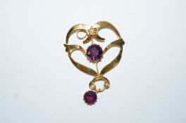An Edwardian amethyst coloured paste and simulated seed pearl pendant, stamped '9c',