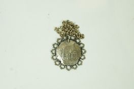 An 18th century Spanish silver piece of Eight, in a later silver mount,