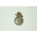 An 18th century Spanish silver piece of Eight, in a later silver mount,