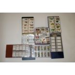 A collection of cigarette cards, fifty complete sets and three trade card albums,