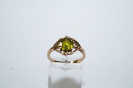 A peridot and diamond dress ring, engraved '14K,