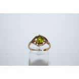 A peridot and diamond dress ring, engraved '14K,