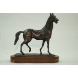 A bronze model of a horse on associated wooden plinth, 42.