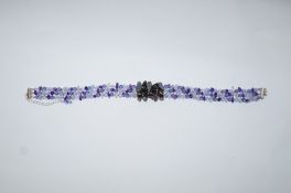 A choker of tumbled amethyst and aquamarine beads centred with black stained dogs tooth freshwater