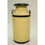 A decorative painted milk churn in cream and black,