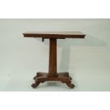 A William IV rectangular centre table with tapering pedestal on shaped base with four carved paw