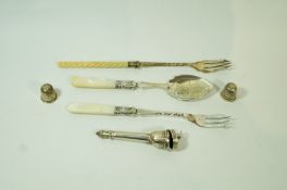 A silver thimble and another thimble; a cigarette holder case; two plated pickle forks;
