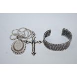 A late Victorian silver locket, circa 1880, monogrammed, on a later chain; a bangle of woven design,