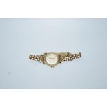 A lady's Longines 9 carat gold round faced wrist watch on 9 carat gold bracelet,