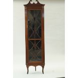 A mahogany standing corner cabinet with broken swan neck pediment above an astragal glazed door