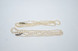 A row of graduated cultured pearls, 2mm to 6mm,with white metal pierced work clasp stamped 9C,