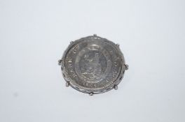 An 1804 silver five shilling coin in a silver plated mount along with a George III silver half