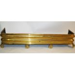 A Victorian brass fender of moulded form, standing on four ball feet, 116cm wide,