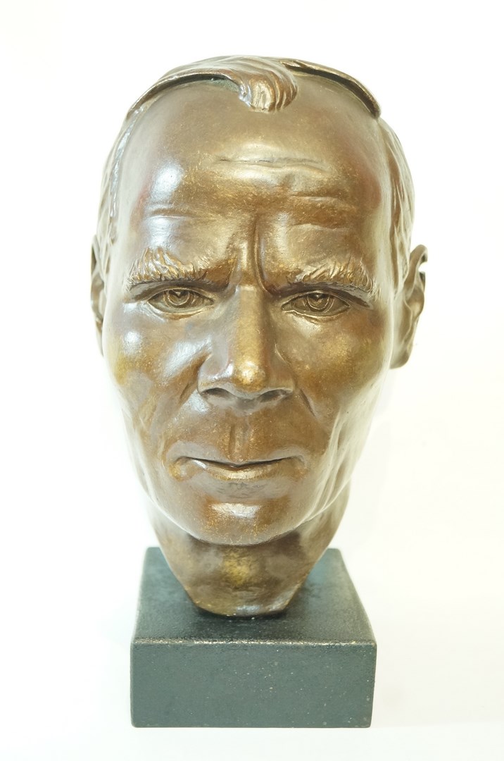A late 20th century plaster bust of a gentleman with bronze patination,