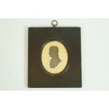 An early 19th century painted silhouette of a gentleman facing left, in rectangular ebonised frame,