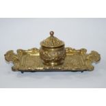 A late 19th century brass inkwell and cover on a two handled stand moulded with Neo-Renaissance