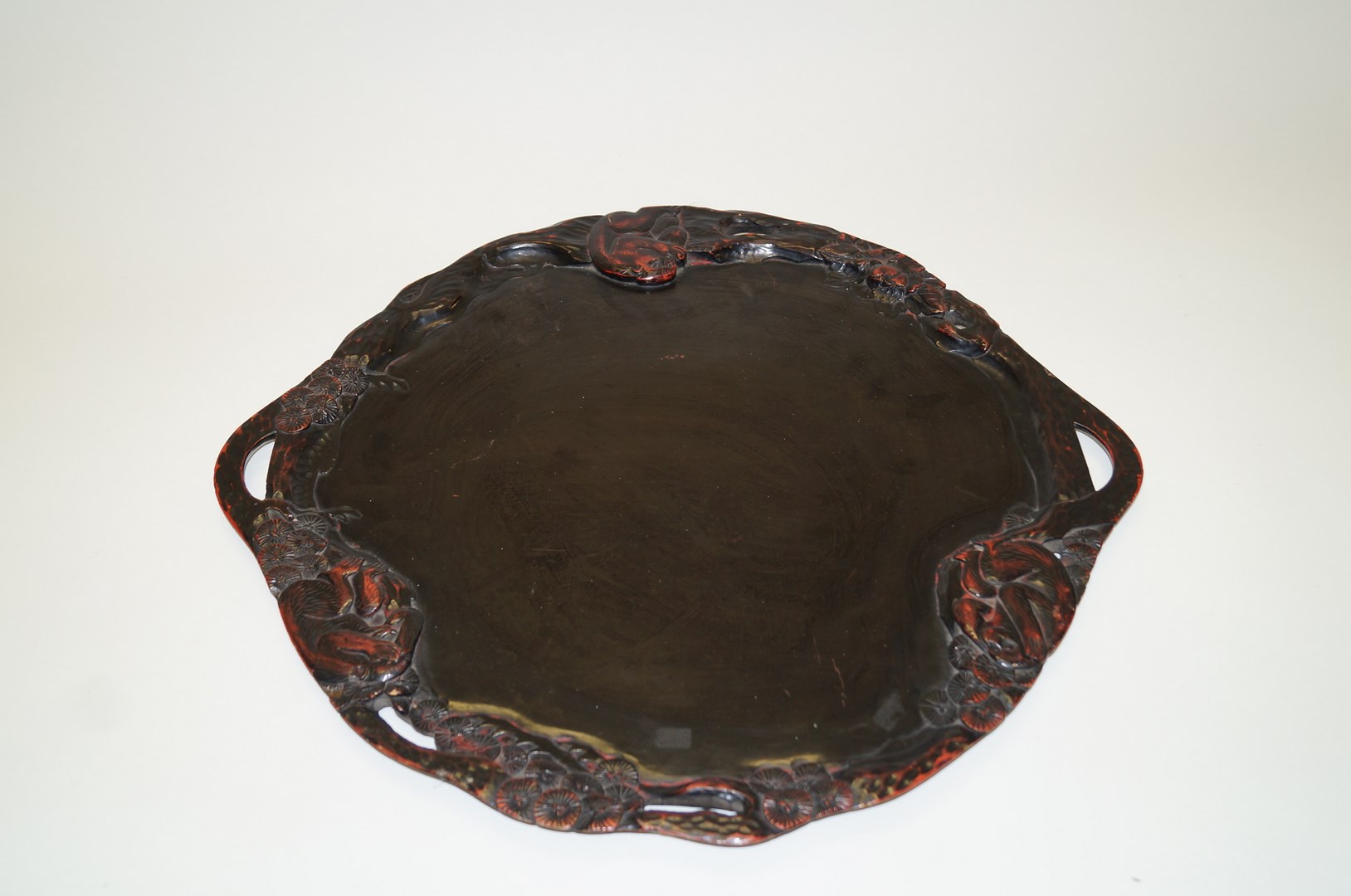 An early 20th century black lacquered Japanese two handled tray,