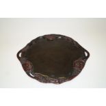 An early 20th century black lacquered Japanese two handled tray,