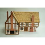 A 20th century model house, the building in Neo Jacobean style, of L form,